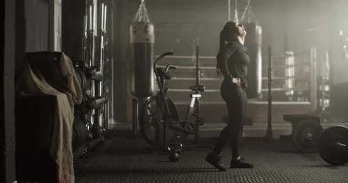 Powerful Sportswoman Walking in Gym During Training