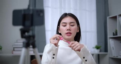Woman Applying Lip Gloss Filming Beauty Vlog