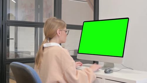 Young Woman Using Desktop with Green Screen