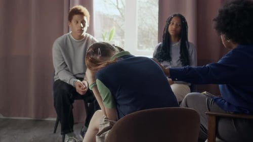 Group Therapy Session with Counselor and Young Adults