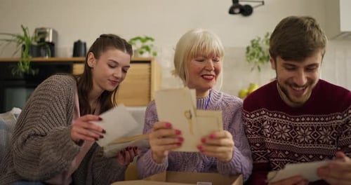 Family Reminiscing, Looking Through Old Photos At Home