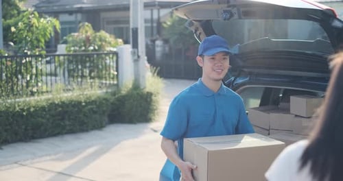 Delivery service male in uniform give cardboard box package to receiver customer client front