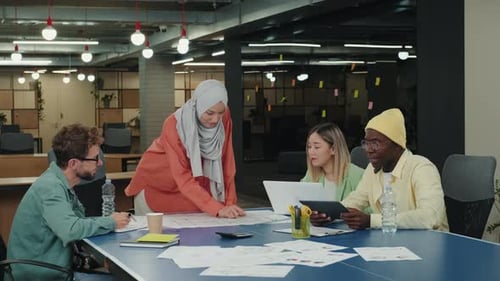 Diverse Team Collaborating on Project in Modern Office