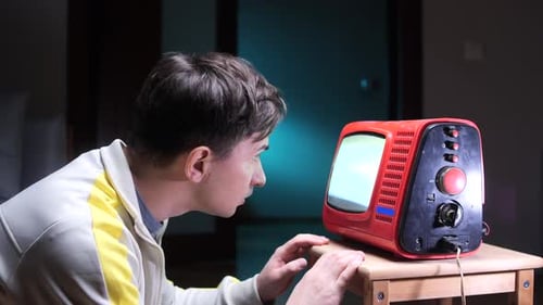Young Adult Watches a Retro Television