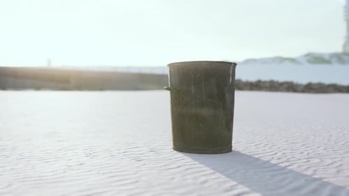 Gray Metal Garbage Bin or Trash Can on the Beach