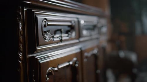 Vintage Wooden Commode with Original Carving Indoors. Close Up Wood Furniture Object
