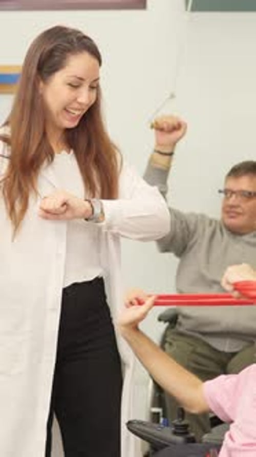 Physical Therapy Session with People Using Exercise Equipment