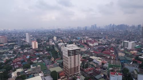 side panning drone shot of manila city philippines on a moody cloudy day