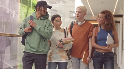 Multicultural Students Walking along Corridor