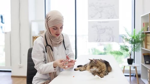Arabian Doctor Preparing for Cat Vaccination in Vet Clinic