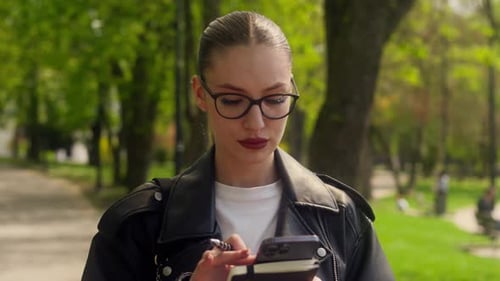 Caucasian Fashionable Confident Woman Walking in Park User Mobile Phone Smartphone Cellphone Virtual