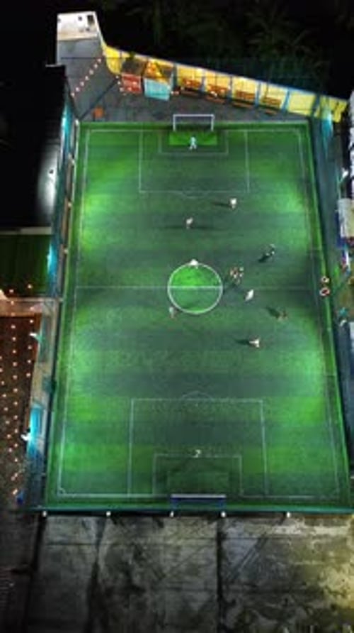 Vertical Drone Footage of mini football match, soccer. MiniFootball field and Footballers from drone