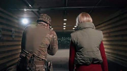 Close Up At a Professional Shooting Range Military Trainer Tells a Girl How to Properly Handle NATO