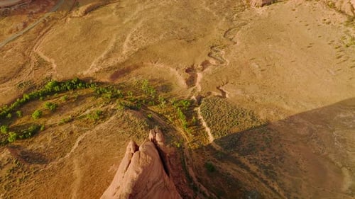 Little greenery growing in the desert landscape. Drone footage over beautiful canyons of Utah, USA.