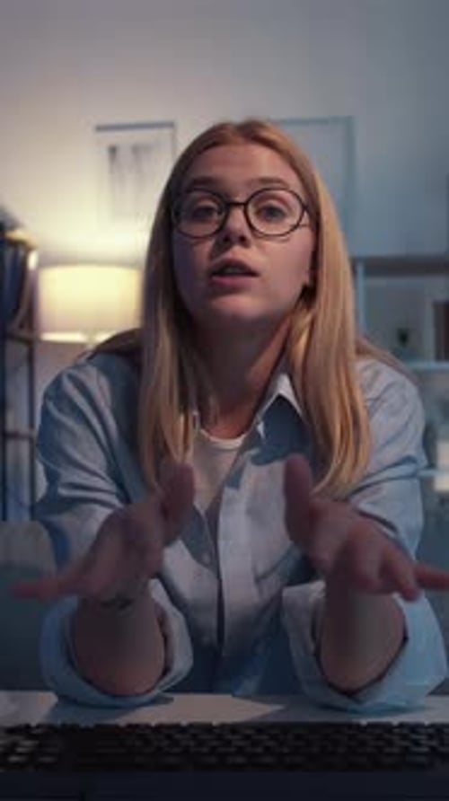 Woman Talking at Desk at Night