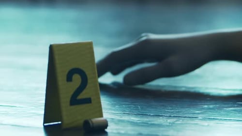 Evidence Marker Near Body at Crime Scene