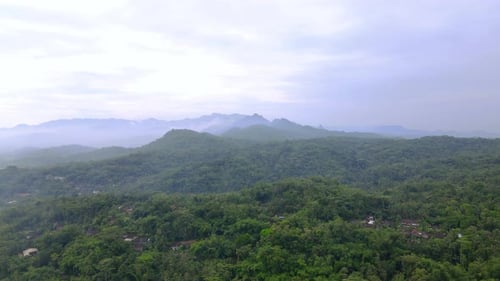 Aerial view of nature landscape with view of rain forest and hill with cloudy sky - Tropical Country