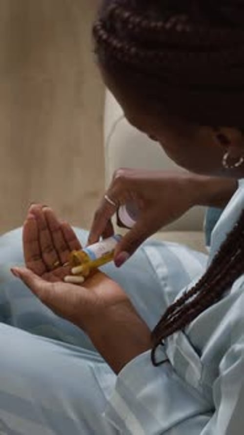 Woman Taking Medication with Water in her Home