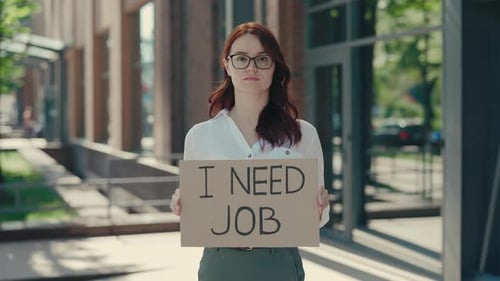 Caucasian Ginger Businesswoman in Glasses Holding Poster Cardboard with Need Job Jobless Message