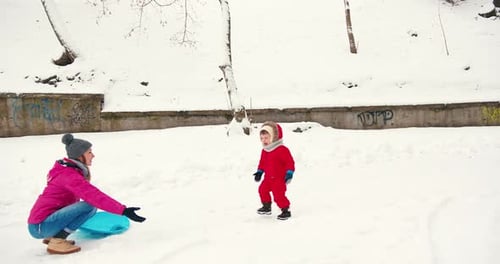 Mother and Child Embracing in Snowy Winter Scene