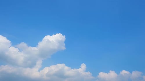 Fluffy clouds moving in the blue sky time-lapse