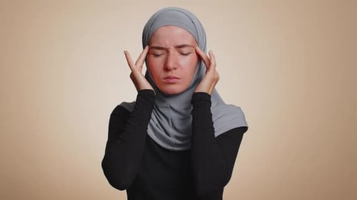 Woman Massaging Temples Experiencing Headache