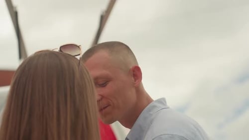 Loving couple kisses near outdoor wedding location