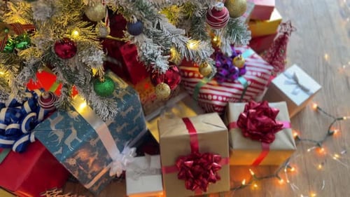 Christmas Presents Under Decorated Tree with Lights