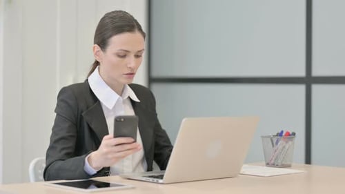 Young Adult Woman Working With Technology in Office