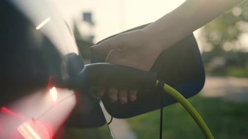 Woman Disconnects Ev Cable From Car Socket at Station