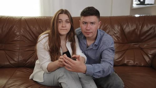 Couple Playing Video Game on Couch Together