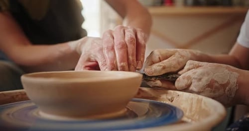 Adult and Child Crafting Pottery Together