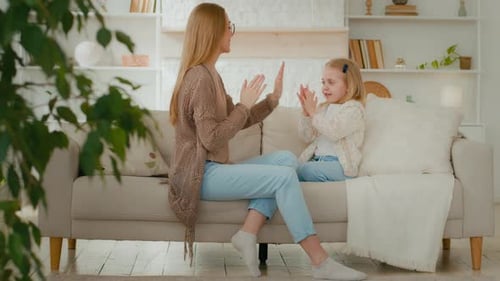 Cheerful Caucasian Mother Mum Female Babysitter and Cute Happy Kid Girl Baby Child Daughter Play