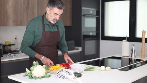 Man Preparing Vegetables in Modern Kitchen at Home