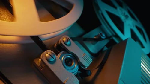 Turning Film Reel on Vintage Movie Projector