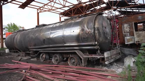 Remains of Tank From Trailer in Damaged Hangar Large Metal Tank From Trailer Abandoned Under Rubble