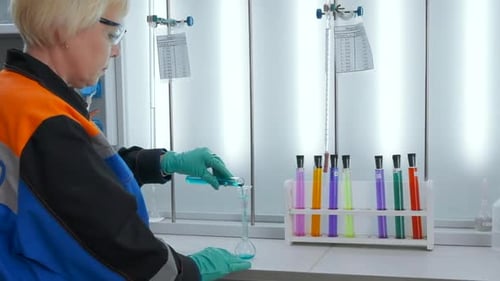 Scientist Pours Blue Liquid in Lab
