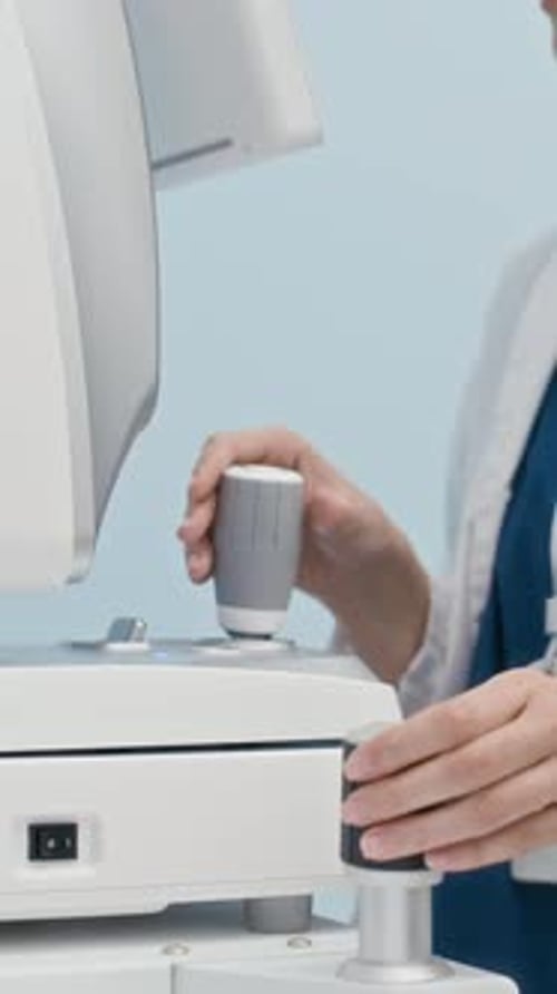 Vertical of Ophthalmologist Using Eye Examination Equipment in Clinic
