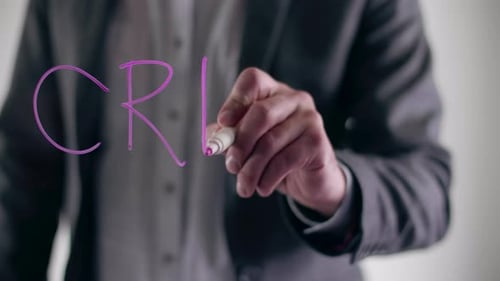 Man Writes a Crisis Word on a Glass Board