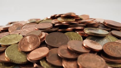 Close-up of rotating metal coins. Rotating pile of euro cents.