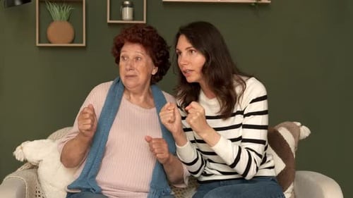 Excited Senior and Young Adult Women Cheering Together