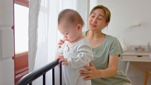 Loving Mother With Adorable Infant By Bright Window