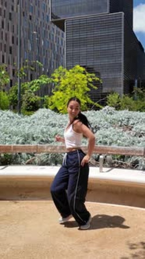 Energetic Woman Dancing in Urban Cityscape
