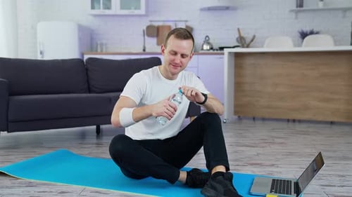 Man Drinking Water After Home Workout