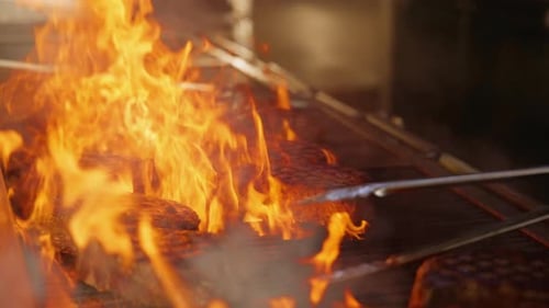 Premium Steaks Cooking in Upscale Restaurant Kitchen with Dramatic Flames Slow