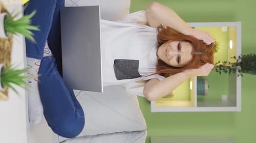 Vertical Video of Frustrated young woman. The woman who got angry with what she saw on the laptop.
