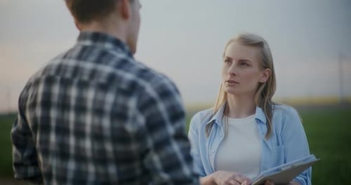 Farmer Explaining Agronomist In Farm