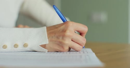 Closeup of Female Hand Writing English Test Education and Knowledge Assessment Concept