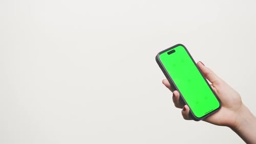 Hand Holding Smartphone with Green Screen on White