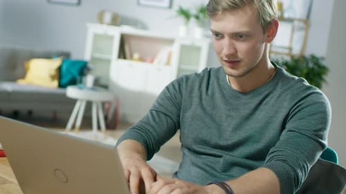 Man Typing on Laptop Inside Bright and Modern Home